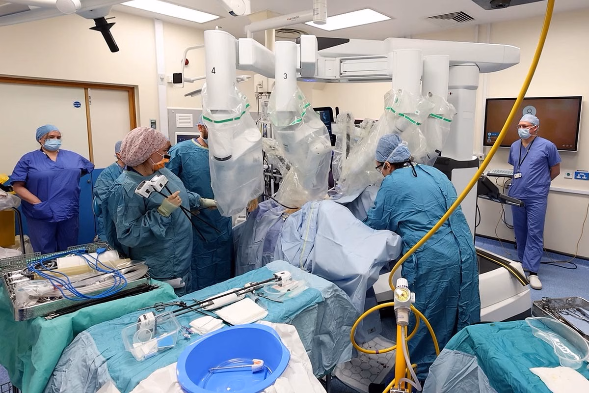 Team of surgeons using advanced piece of medical equipment