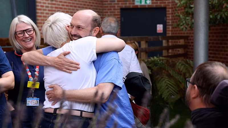 People hugging outside a hospital
