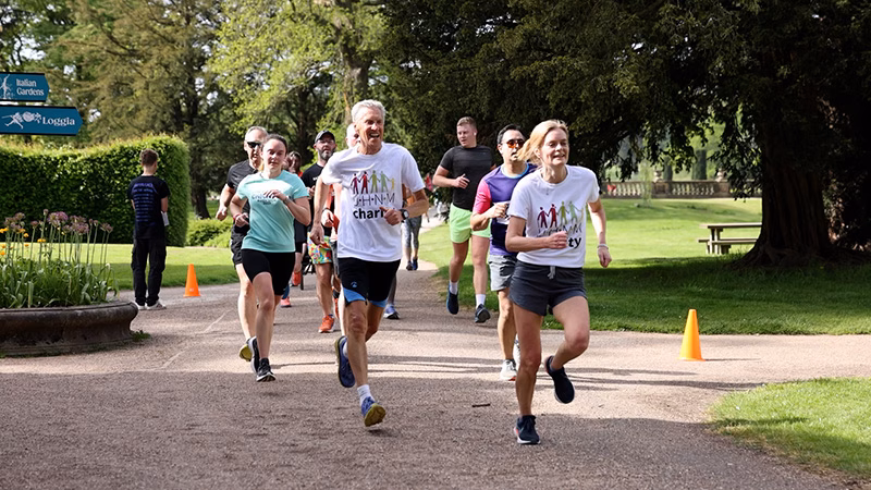 People running wearing UHNM Charity t-shirts